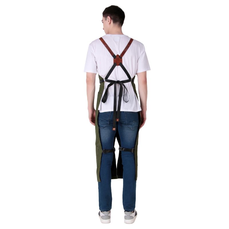 Person wearing a green apron with suspenders on a white background