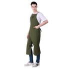 Person wearing a green apron over a white shirt and blue jeans on a white background