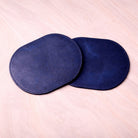Two blue silicone breast pads on a light pink background