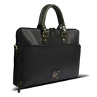 Black handbag with green handles on a white background