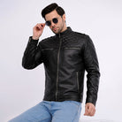 Man wearing a black leather jacket and sunglasses on a white background