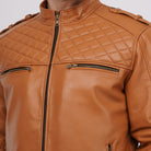 Brown leather jacket with quilted pattern and zippers on a neutral background