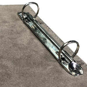 Metal clip on a gray textured surface