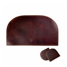 Brown leather placemat set with two coasters on a white background