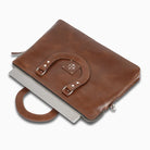 Brown leather briefcase with laptop on a white background
