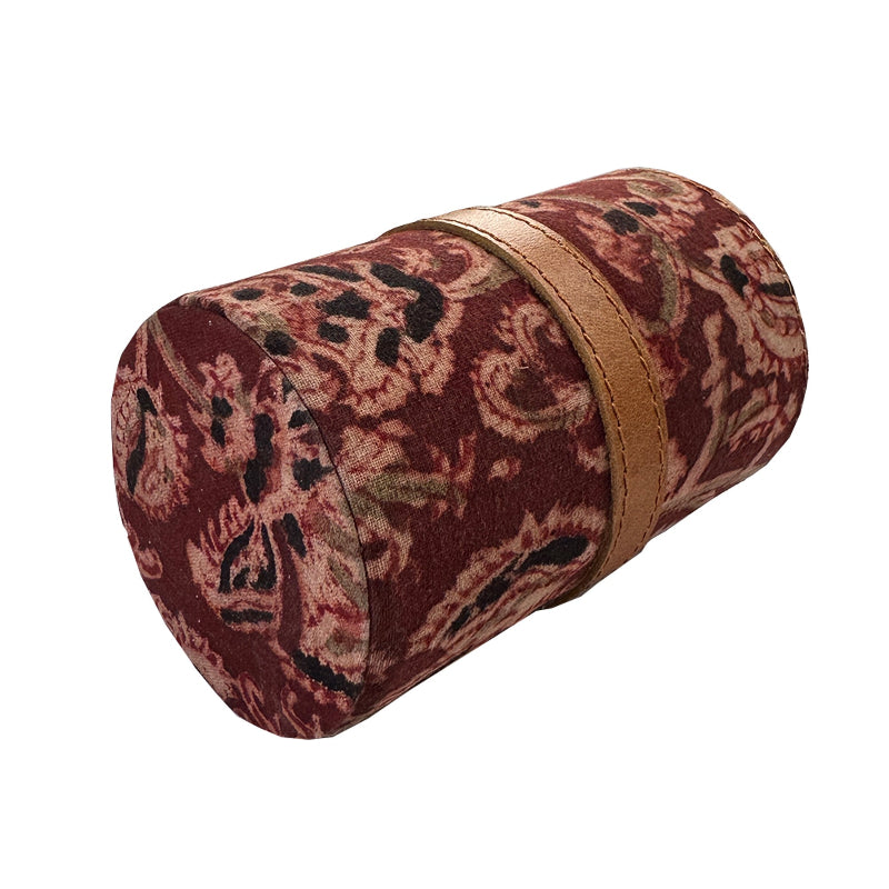 Cylindrical pouch with paisley pattern and gold band on a white background