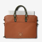 Front view of a brown leather laptop bag with navy handles and shoulder strap.