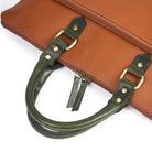 Close-up of a brown leather bag featuring a stitched square logo patch and black straps.