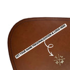 Brown leather placemat product with customizable text and logo area on a white background