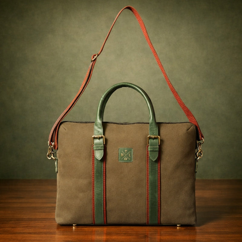 Brown leather bag with green accents on a wooden surface and green background