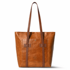 Brown leather tote bag with a visible brand logo on a white background
