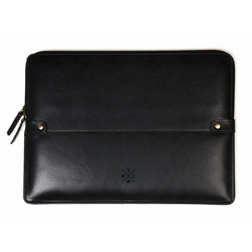 A black leather laptop sleeve with a front strap closure, gold-tone snap buttons, and a small embossed logo, shown on a plain white background.