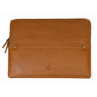 A tan leather laptop sleeve with a front flap pocket, metal snap buttons, and a small embossed logo, shown on a plain white background.