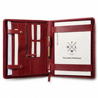 Open red leather portfolio with pen holder and document pockets.