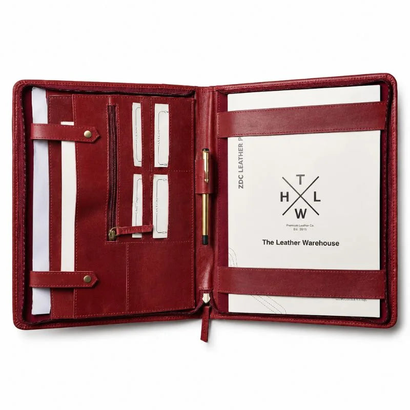 Open red leather portfolio with pen holder and document pockets.