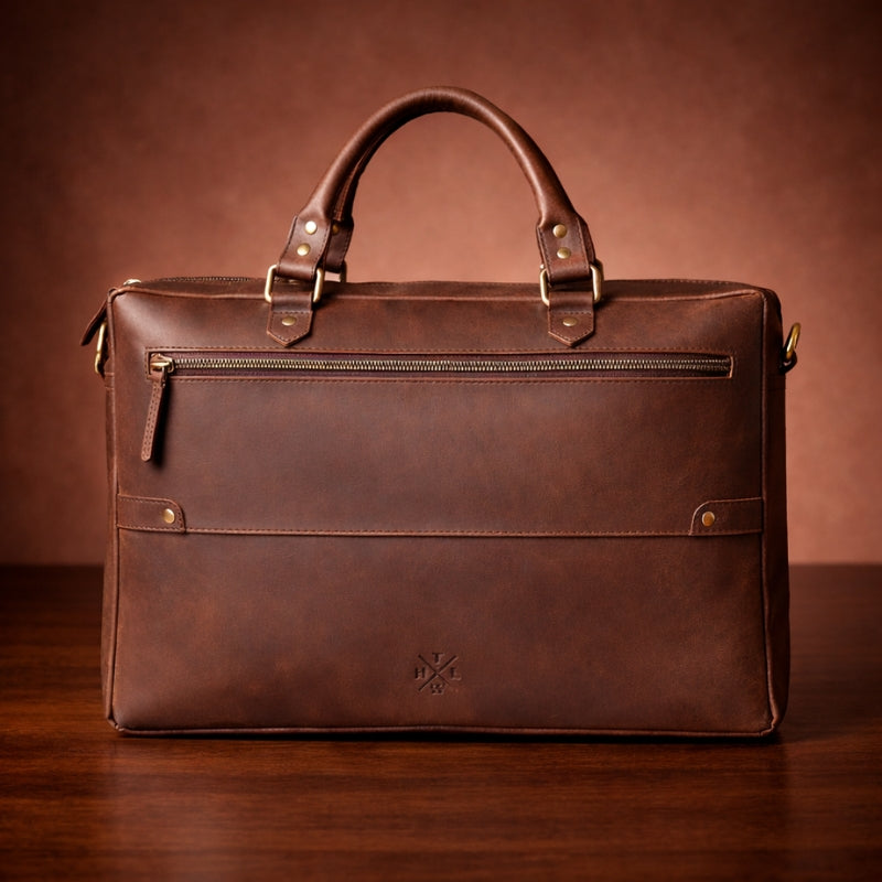 Brown leather briefcase on a wooden surface with a brown background