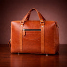Brown leather briefcase on a wooden surface with a brown background