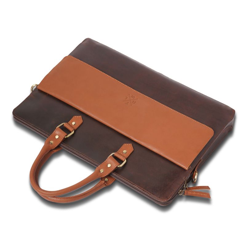 Brown leather laptop bag  with a matching brown strap on a white background