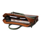 Brown leather laptop bag with green interior and handle on a white background