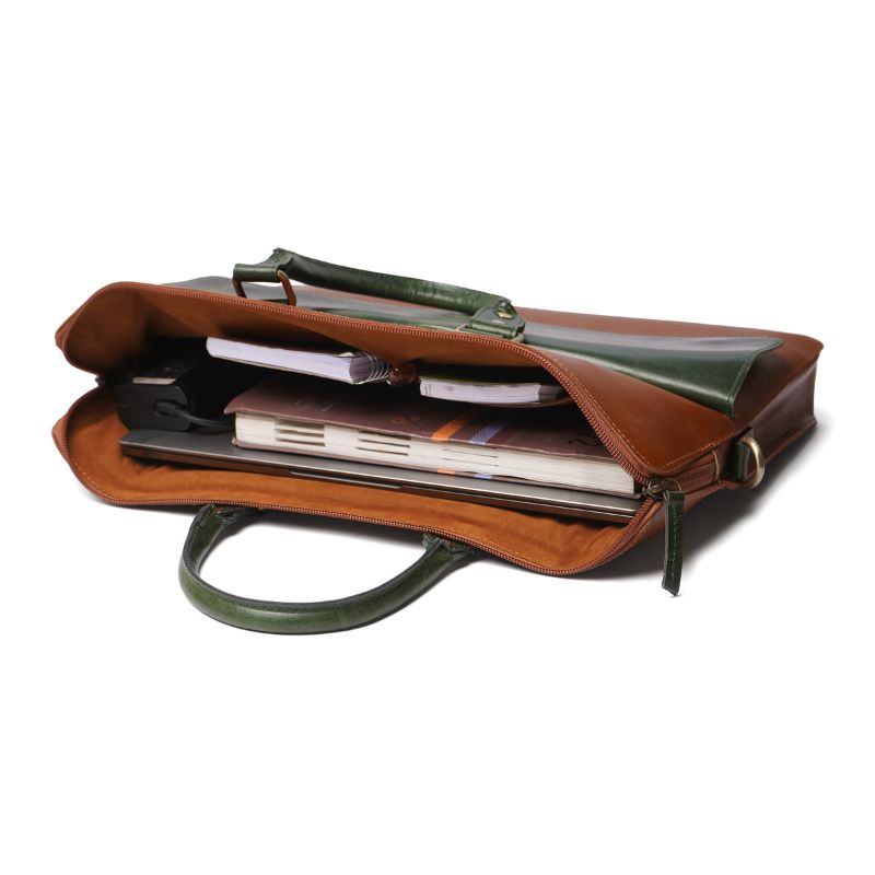 Brown leather laptop bag with green interior and handle on a white background
