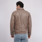Man wearing a brown leather jacket on a white background