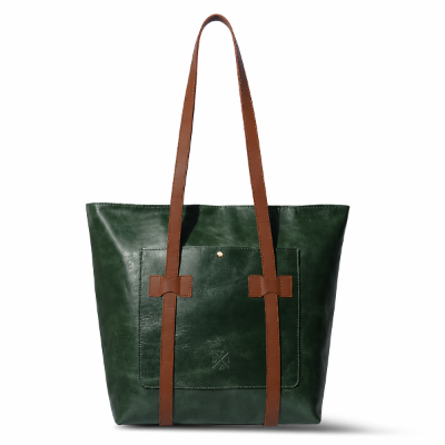 Green leather tote bag with brown straps on a white background