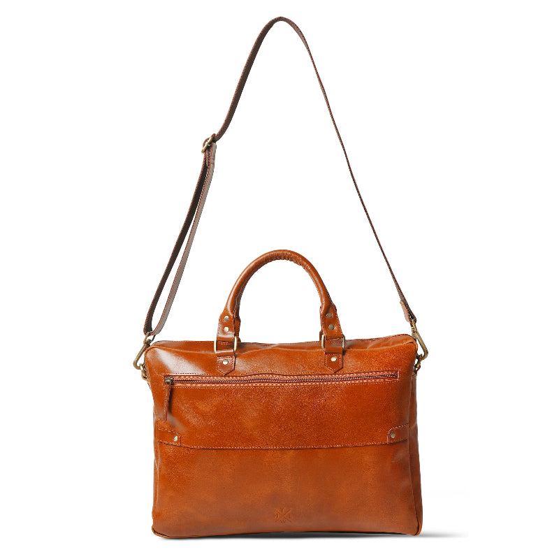 Brown leather bag with a shoulder strap on a white background