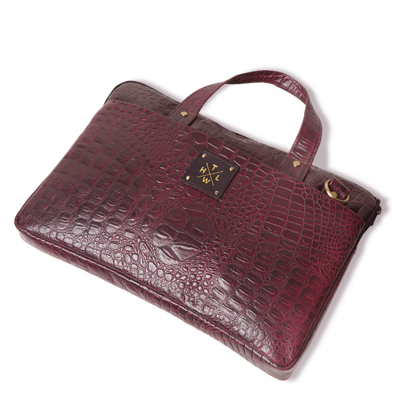 Maroon crocodile skin briefcase on a white background