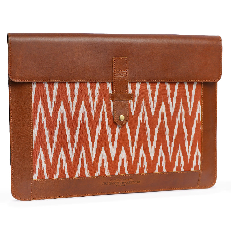 Brown leather and patterned fabric sleeve on a white background