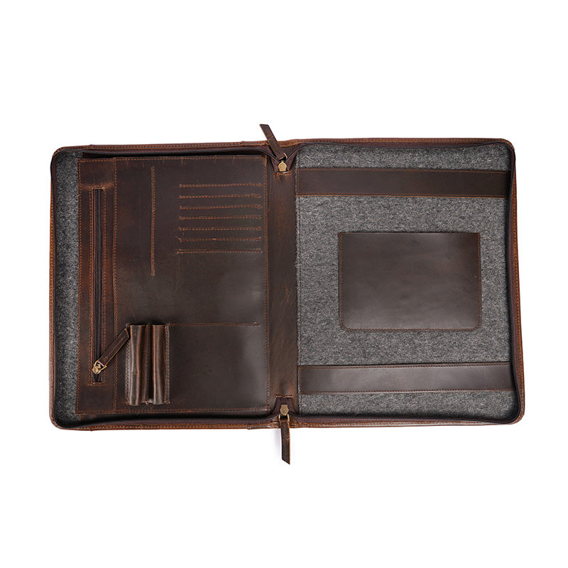 Open brown leather portfolio organizer with multiple pockets card slots pen holders and a padded compartment for documents and tablets displayed on a white background.