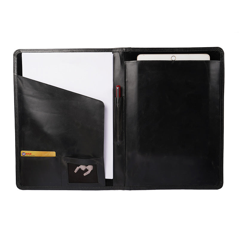 Open black leather file folder with organized compartments, card slots, a pen holder, zipper pocket, and a notepad labeled “The Leather Warehouse” inside.