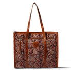 Brown tote bag with intricate pattern and visible brand logo on a white background