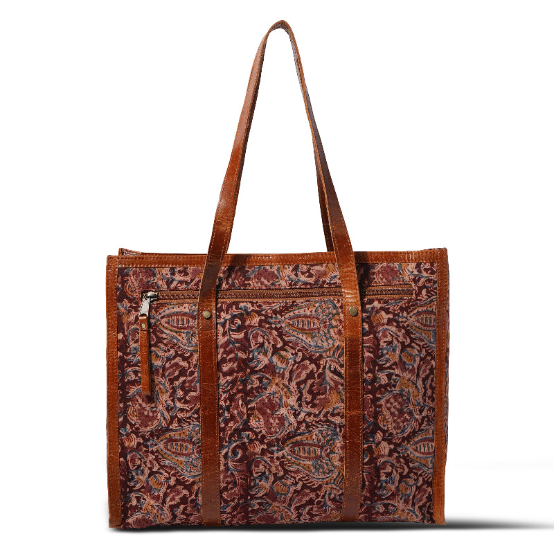 Brown patterned tote bag with leather handles on a white background