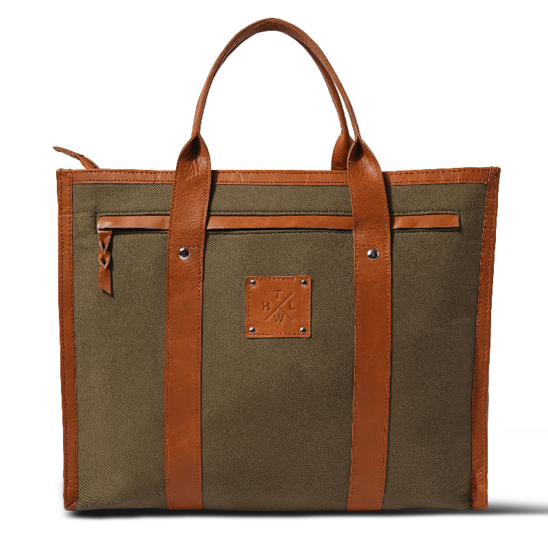 Brown tote bag with leather straps on a white background