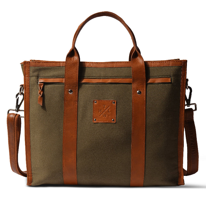 Olive green canvas tote bag with brown leather handles trim and detachable shoulder strap front view on white background
