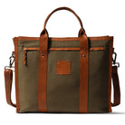 Brown leather and canvas tote bag with visible brand logo on a white background
