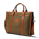 Green bag with brown leather straps and handle on a white background