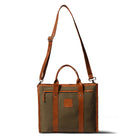 Brown leather and fabric tote bag with shoulder strap on a white background