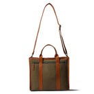 Brown and beige tote bag with leather straps on a white background