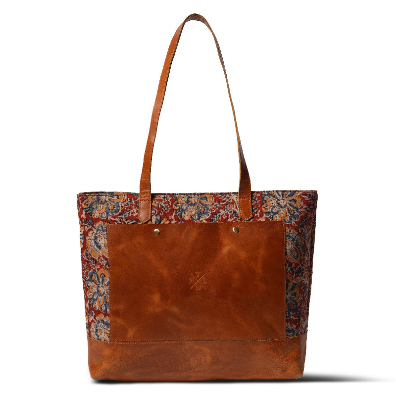 Brown leather tote bag with floral patterned sides on a white background