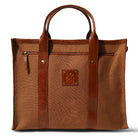Brown leather tote bag with a visible brand logo on a white background
