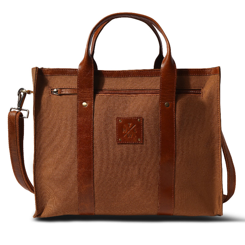 Brown leather tote bag with a visible brand logo on a white background