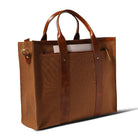 Brown leather tote bag on a white background