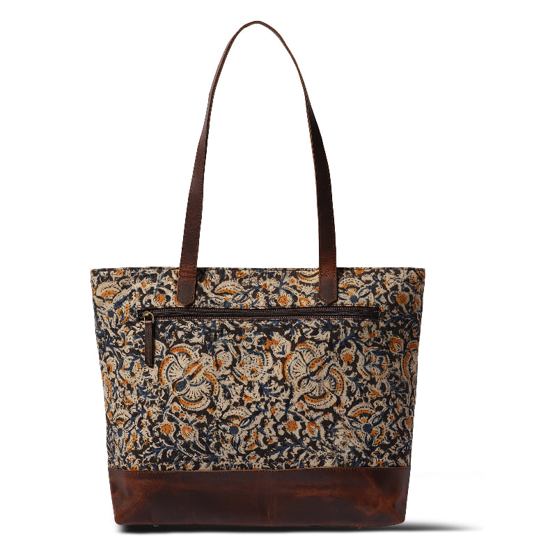 Tote bag with floral pattern and brown leather accents on a white background
