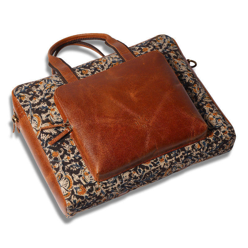 Brown leather briefcase on a floral fabric surface