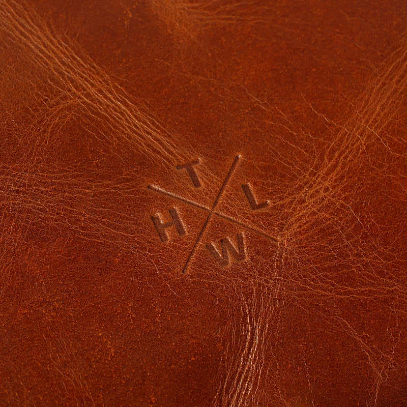 Close-up of brown leather with a embossed logo