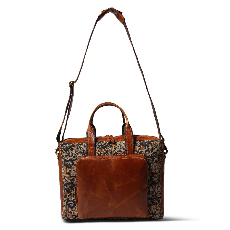 Brown leather bag with floral pattern on a white background