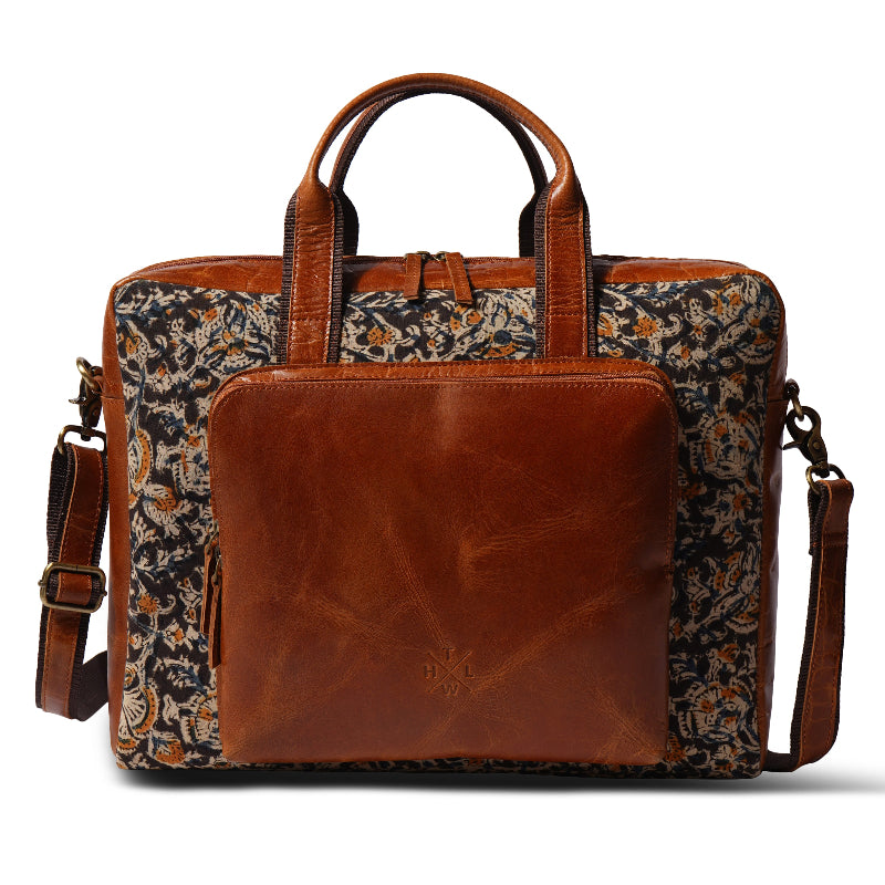 Brown leather briefcase with floral patterned fabric on a white background