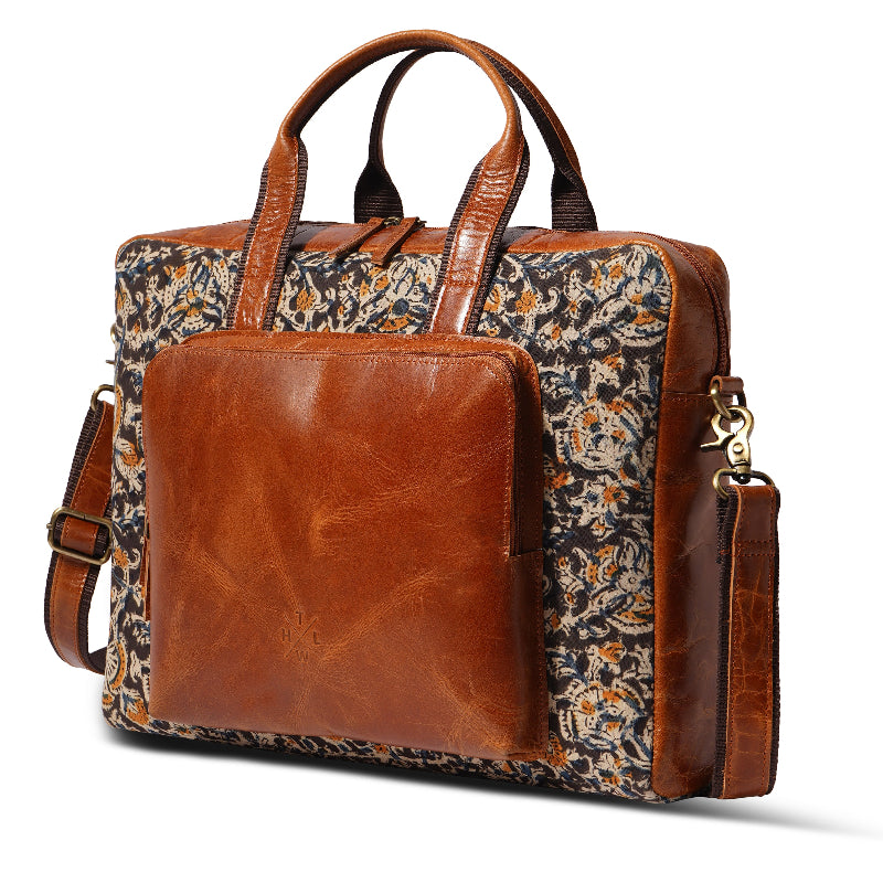 Brown leather and floral fabric bag on a white background