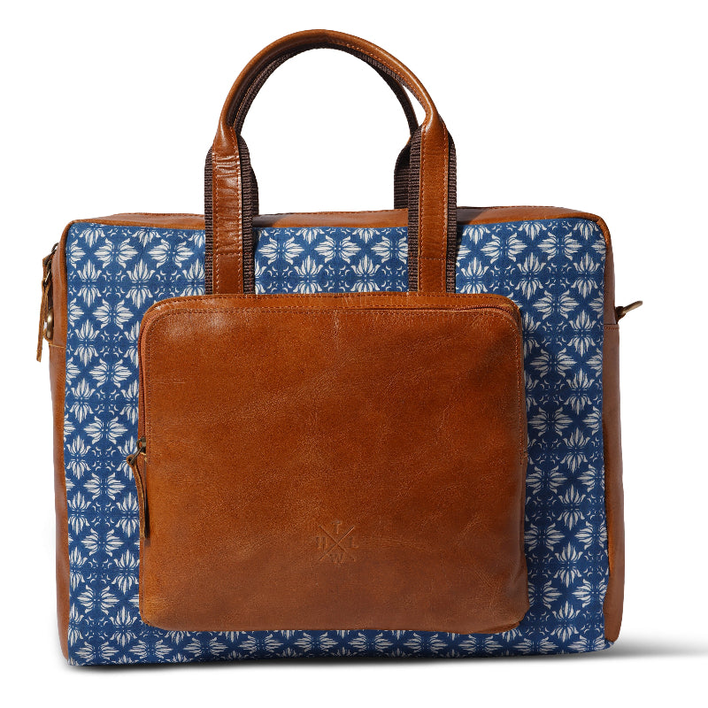 Brown leather briefcase with blue patterned cover on a white background